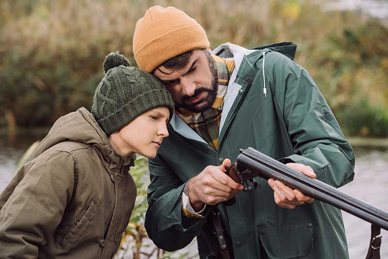 father and son waterfowl hunting on private land